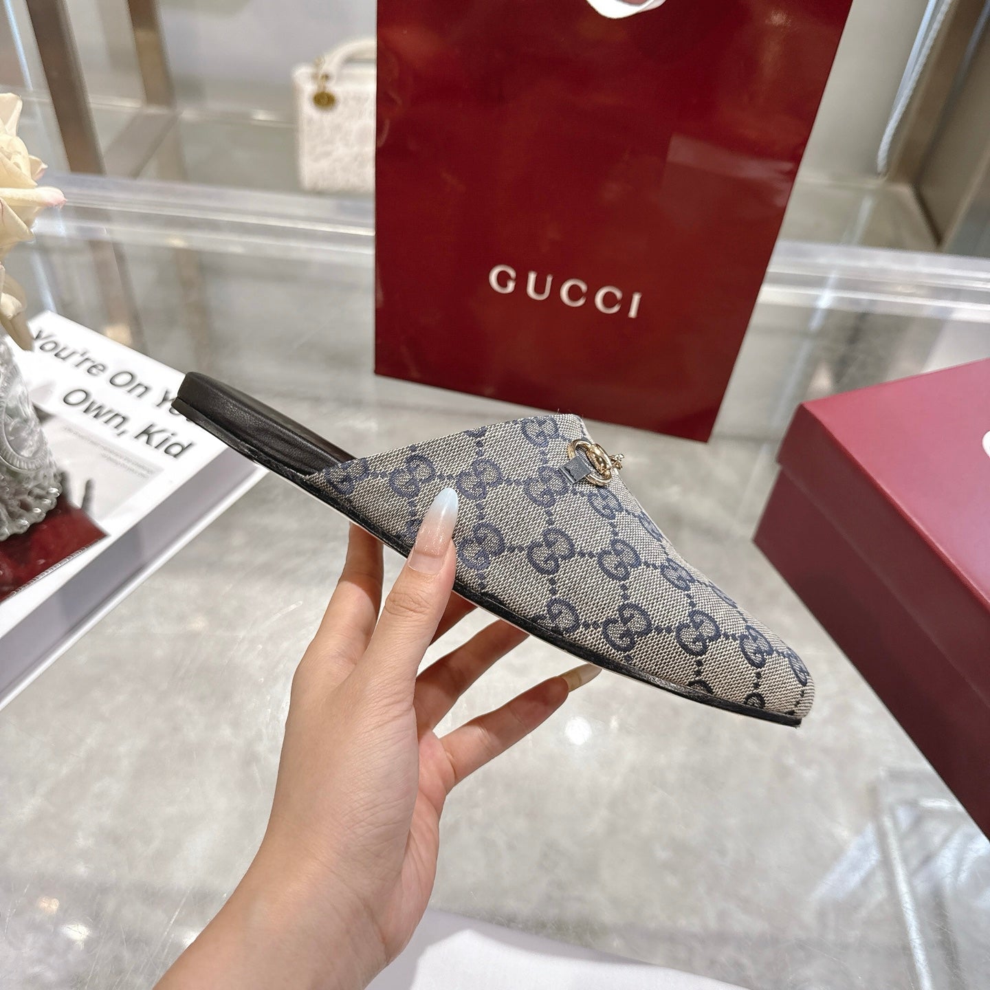 Gucci unisex GG monogram slide sandal with gold-toned horsebit detail, side view