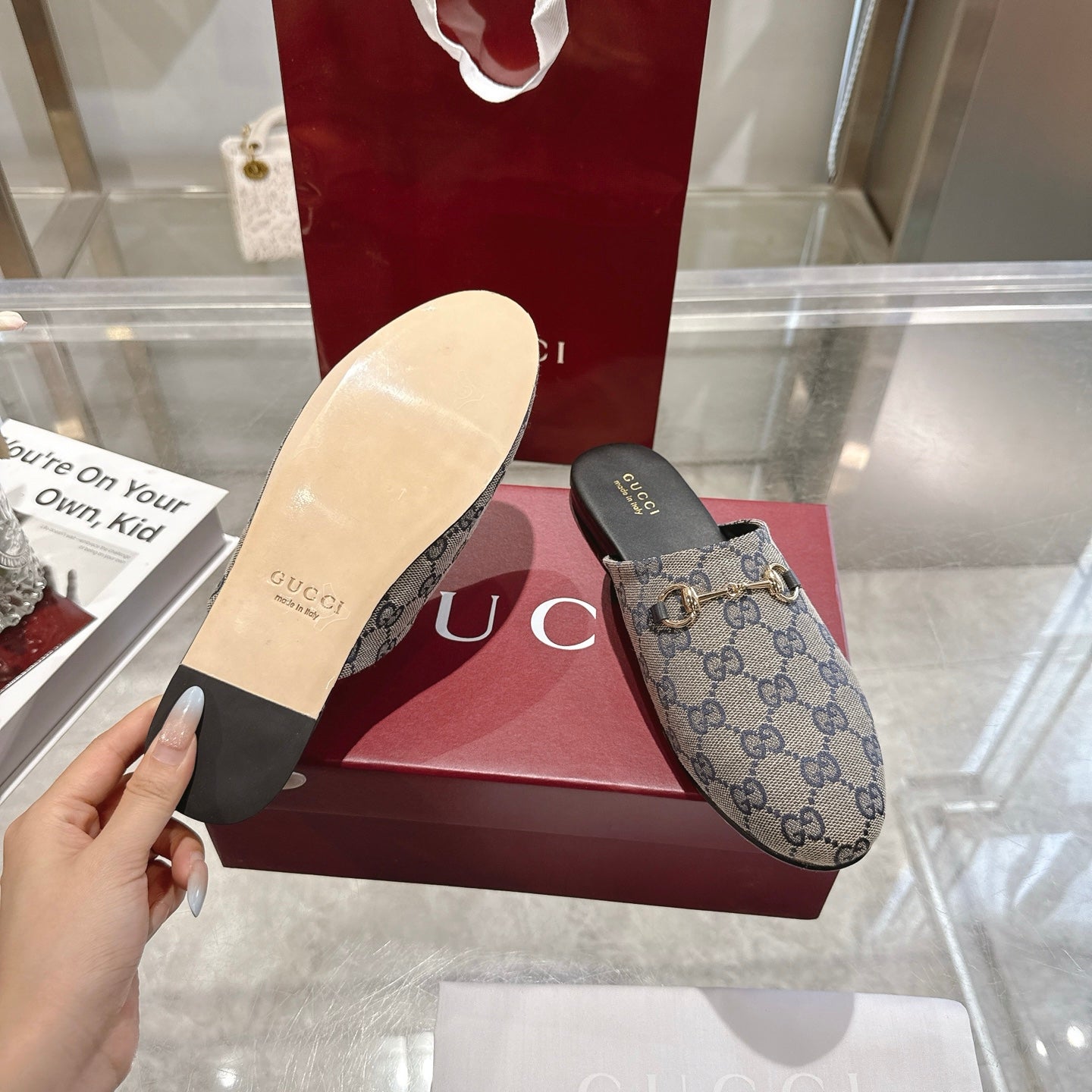 Gucci unisex slide shoes showing light sole and blue-toned GG upper with horsebit