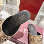 Gucci unisex mule close-up: GG canvas upper with black footbed