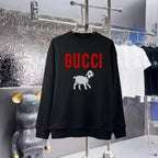 Black sweatshirt with GUCCI logo and cartoon dog graphic, crew neck, long sleeves