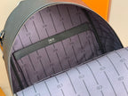 Backpack interior lining with multiple card slots and printed CD-style pattern.