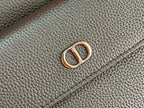 Close-up of dark blue bag hardware with Dior emblem