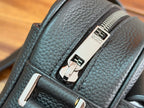 Dark blue bag exterior with zipper pulls and metal strap hardware