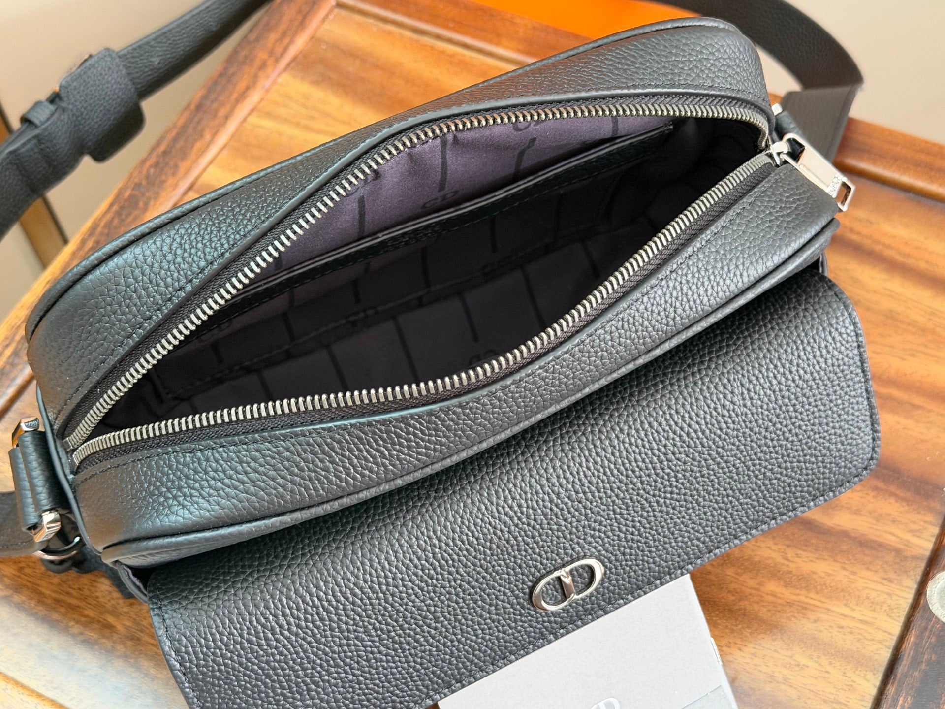Dark blue bag interior view with zipper opening and front logo