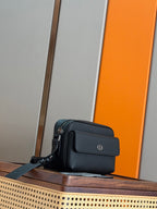 Dark blue crossbody bag with flap front and side pocket