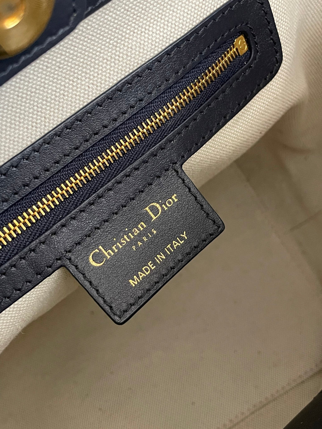 Christian Dior logo leather label on cream lining inside monogram bag