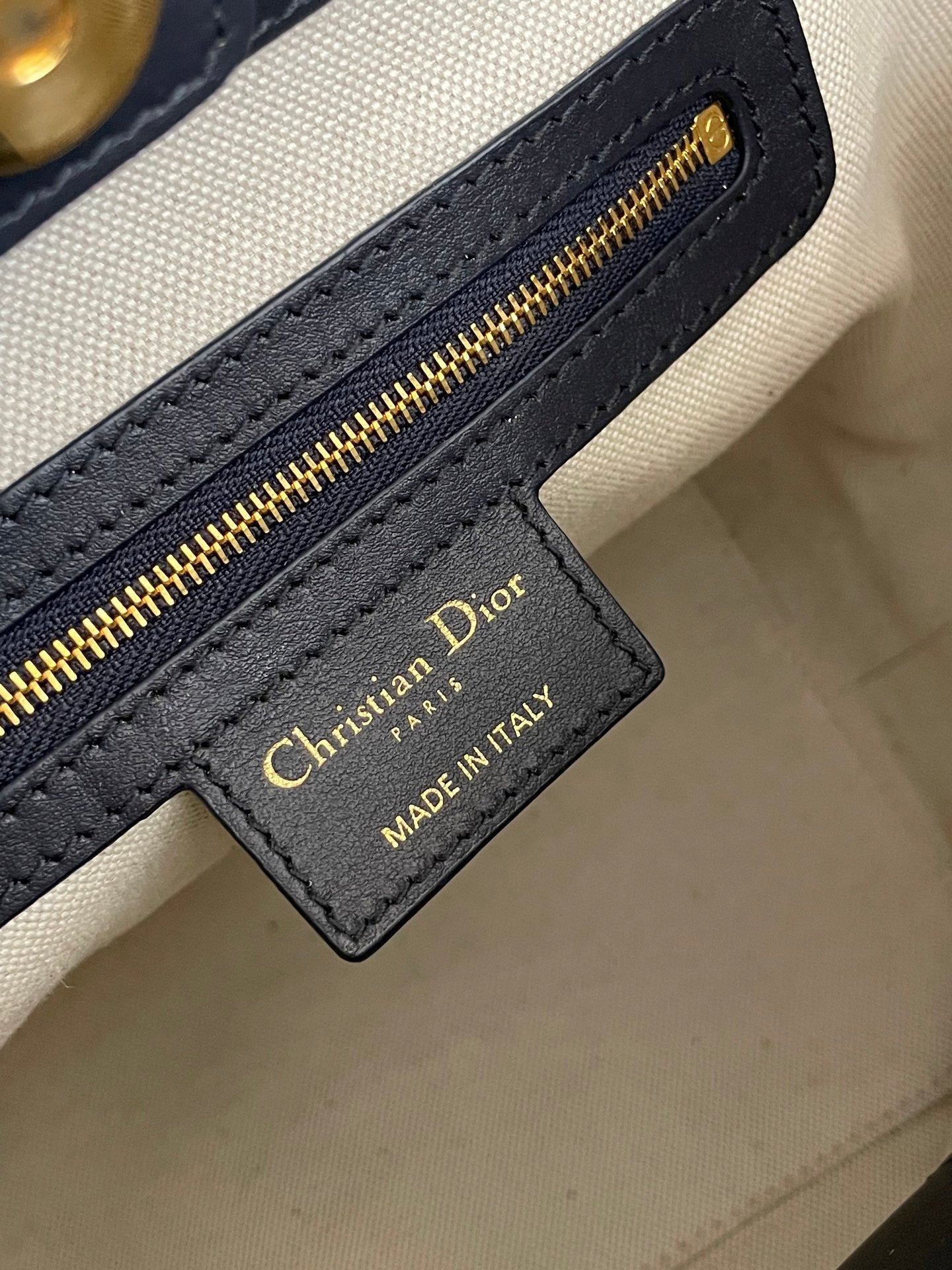 Christian Dior logo leather label on cream lining inside monogram bag