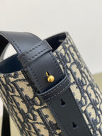 Navy leather strap with logo stud detail on Dior monogram bag