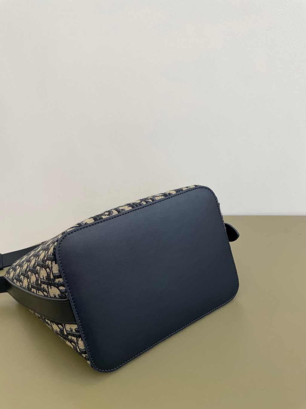 Navy and beige monogram shoulder bag with curved front flap