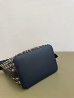 Navy and beige monogram shoulder bag with curved front flap