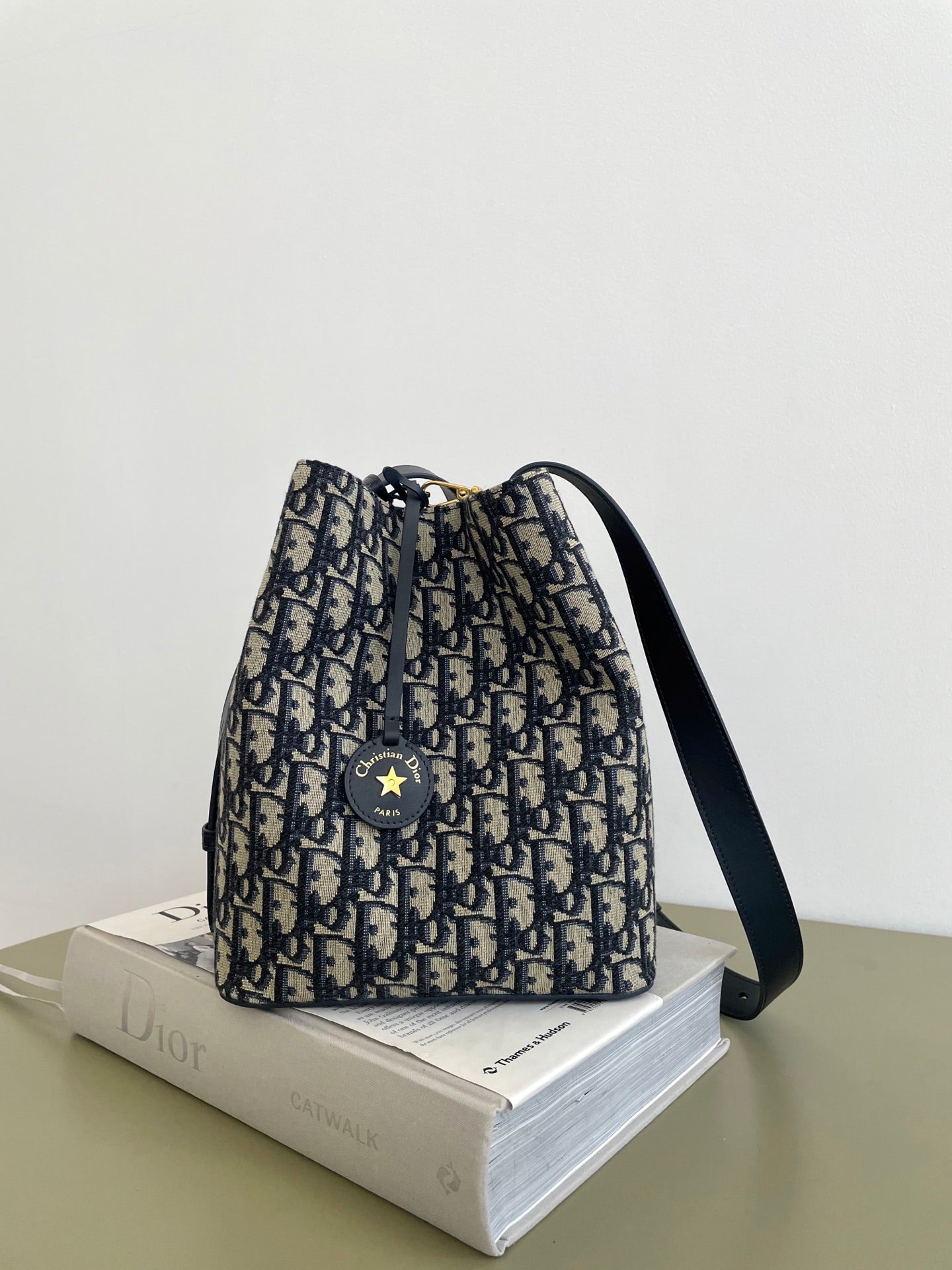 Small drawstring bucket bag in navy and beige Dior monogram print