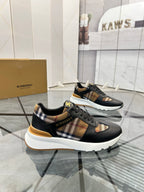 Black lace-up sneakers with plaid side insert and tan-gold trim detail