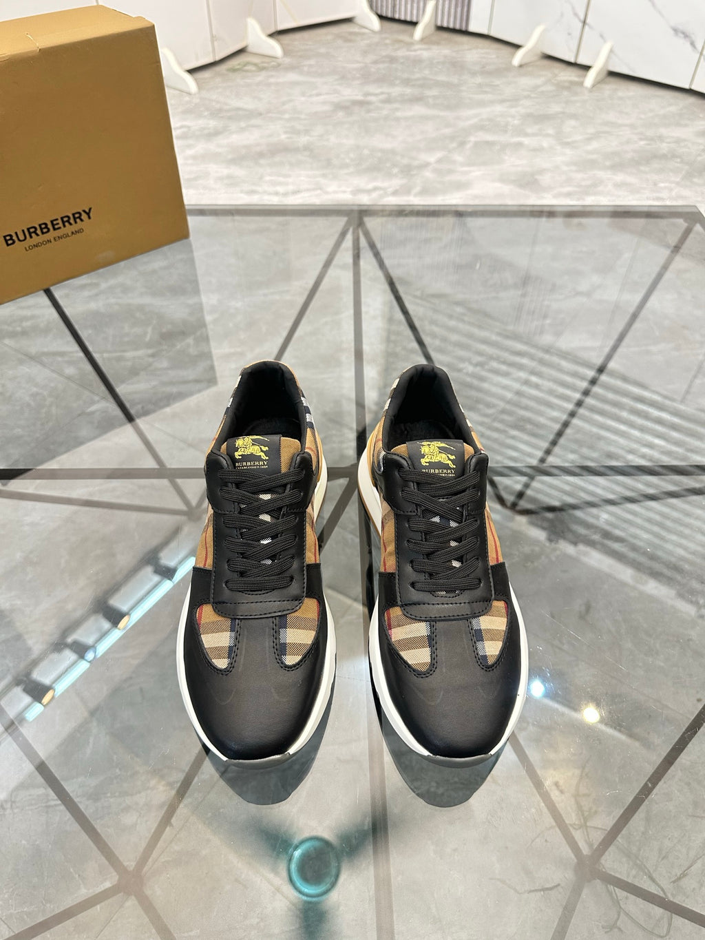 Black lace-up sneakers with yellow accent patch and patterned side panels
