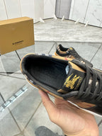 Black lace-up sneaker shown from inside edge, logo embroidery on tongue
