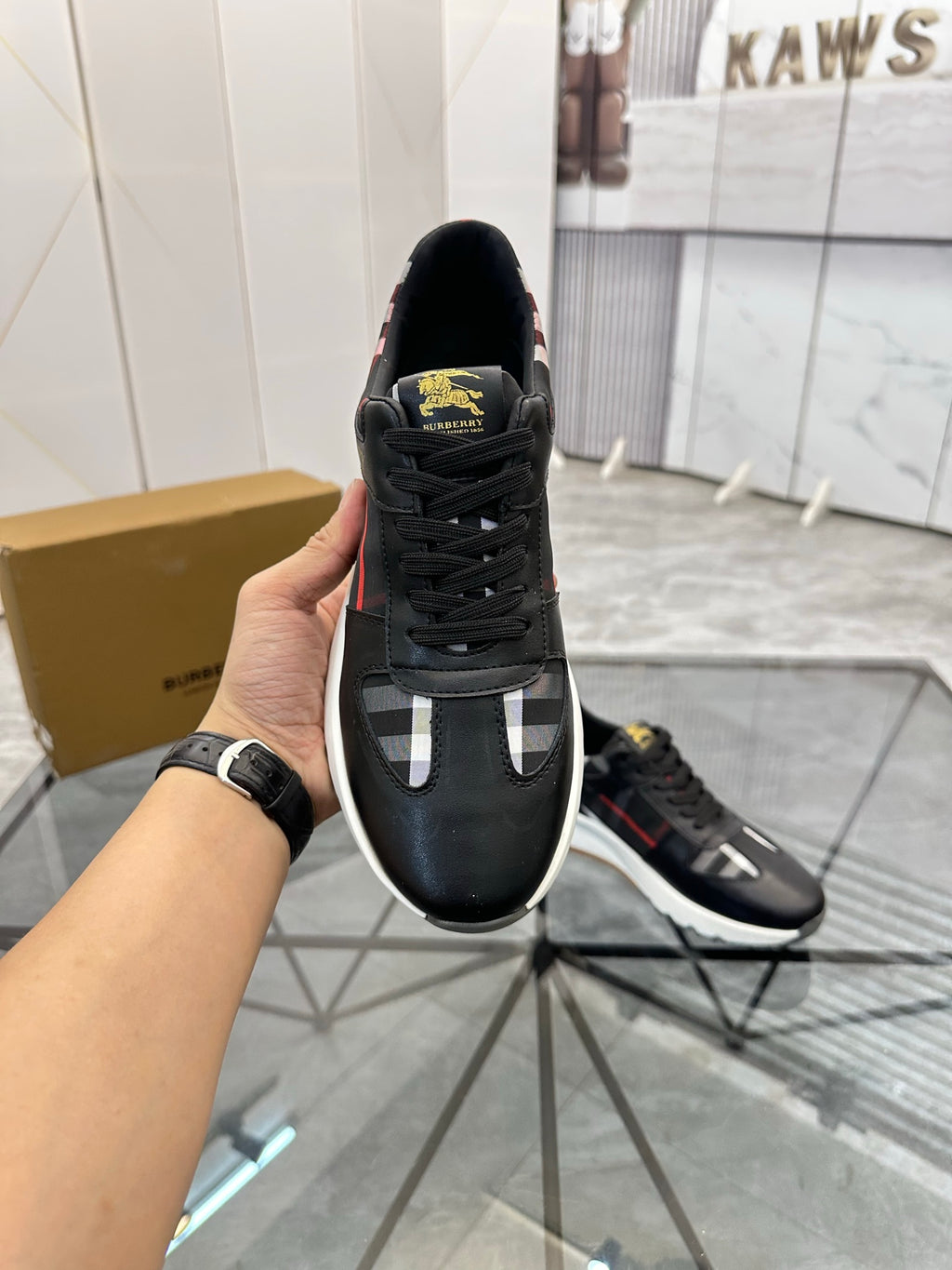 Black low-top sneakers with plaid toe panel and contrasting white details