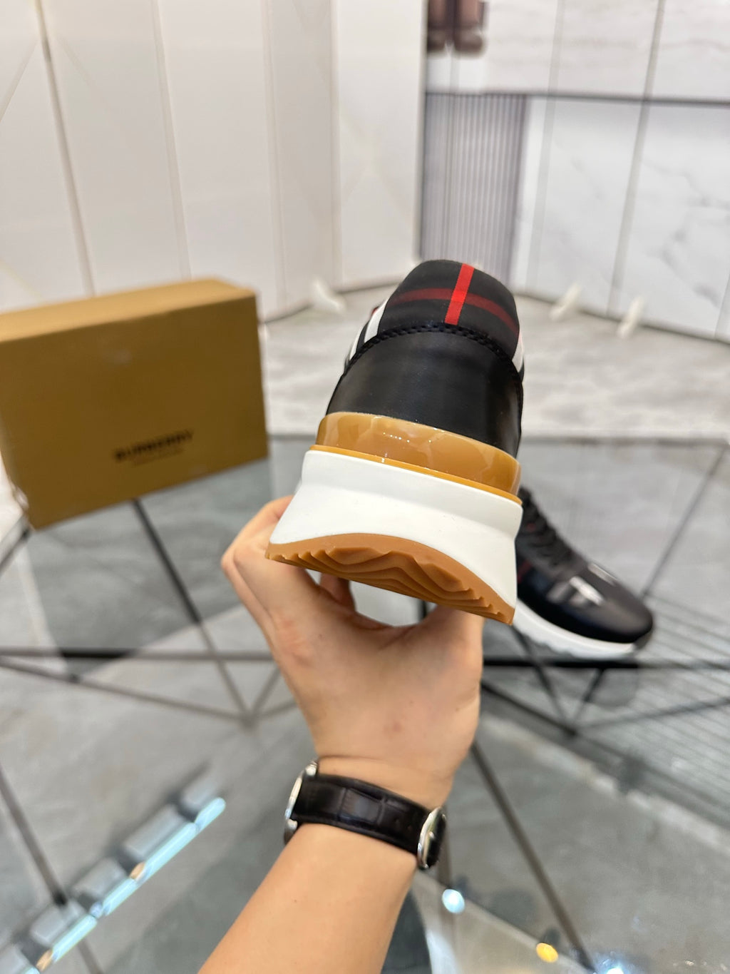 Black low-top sneaker heel with gum outsole and plaid collar accents