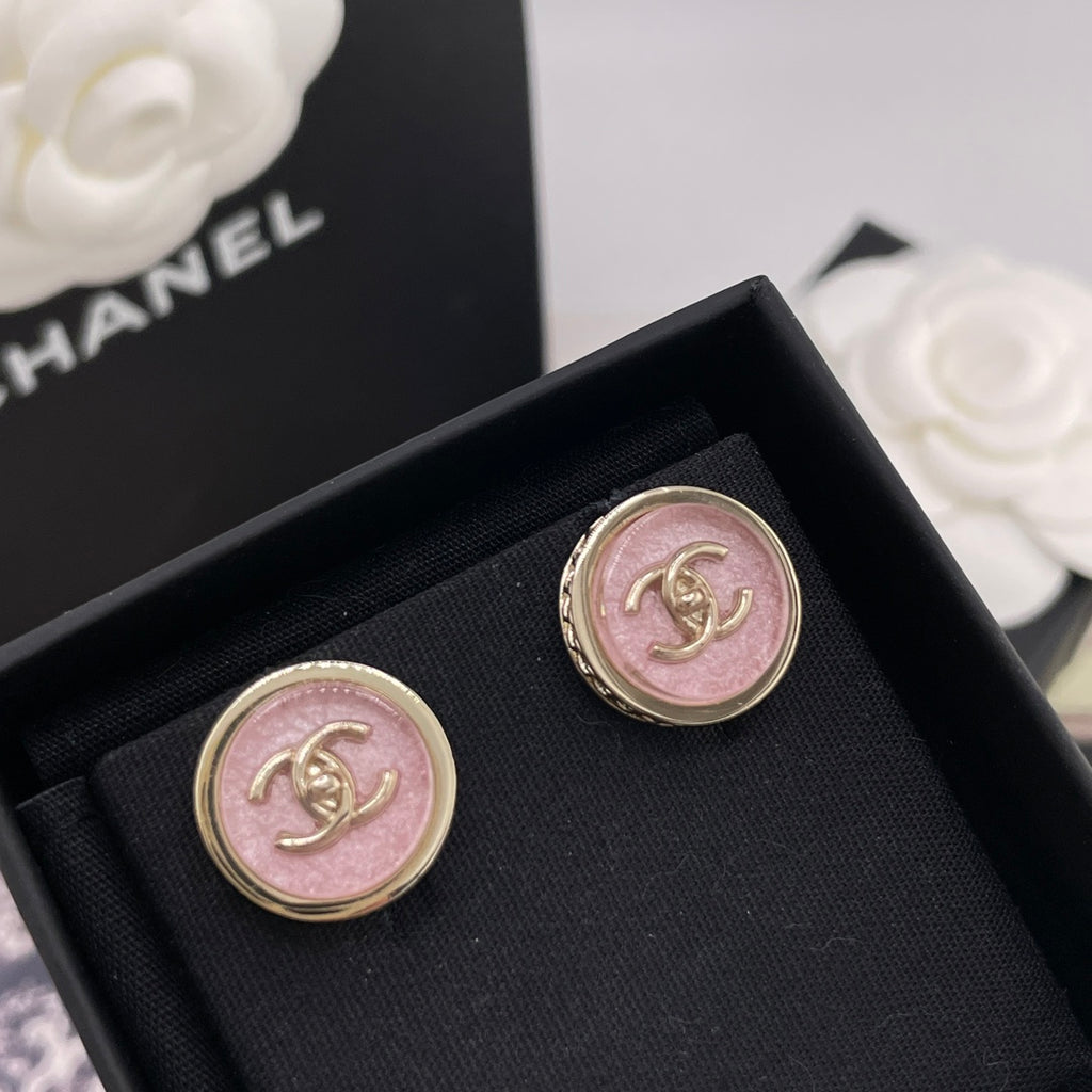 Round Chanel stud earrings with pink CC logo in gold-toned border