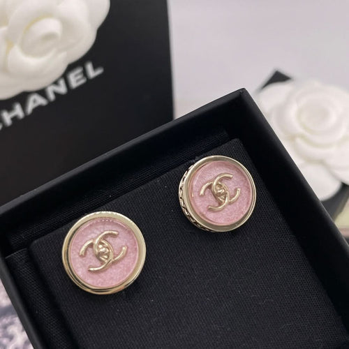 Round Chanel stud earrings with pink CC logo in gold-toned border