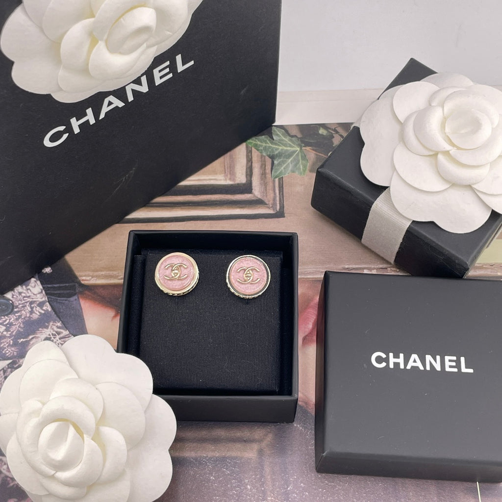 Chanel stud earrings in a black box with pink CC logo medallions