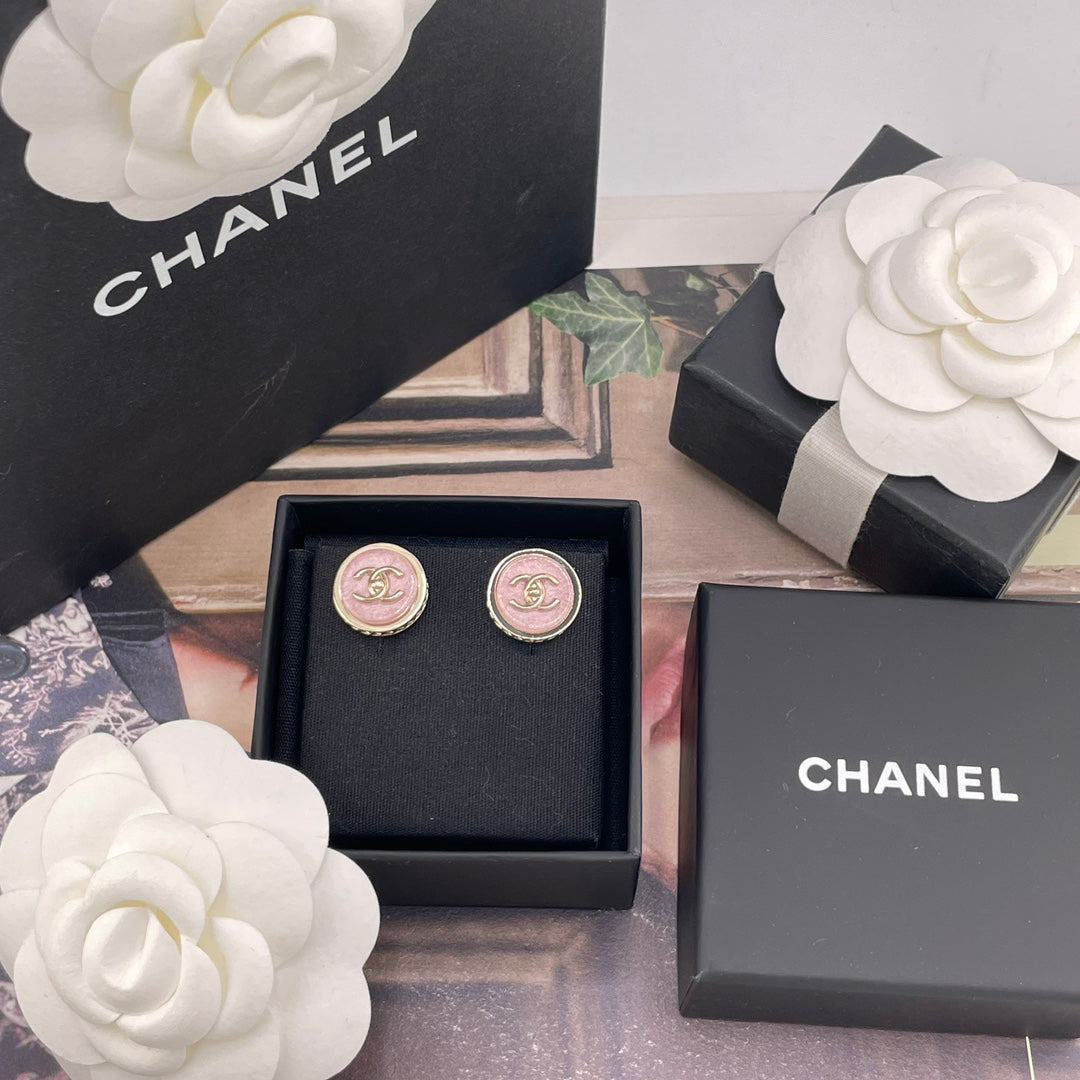 Chanel stud earrings in a black box with pink CC logo medallions