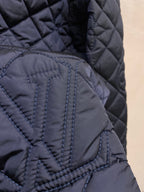 Louis Vuitton quilted jacket texture close-up, stitched diamond pattern