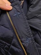 Louis Vuitton jacket detail, embroidered floral motif near gold zipper