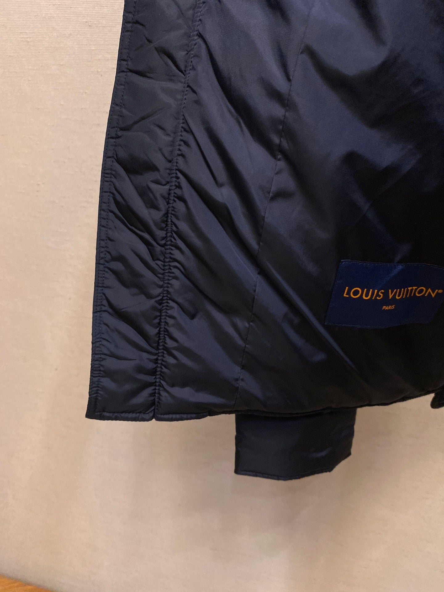 Louis Vuitton long jacket side view with Louis Vuitton logo patch