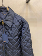 Louis Vuitton quilted long jacket close-up, gold-tone zipper and logo charm