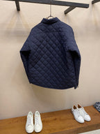 Navy quilted jacket back view on hanger