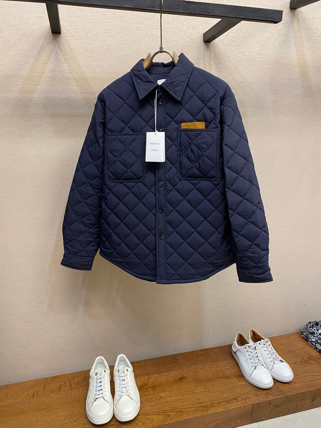 Navy quilted jacket with stand collar and button front