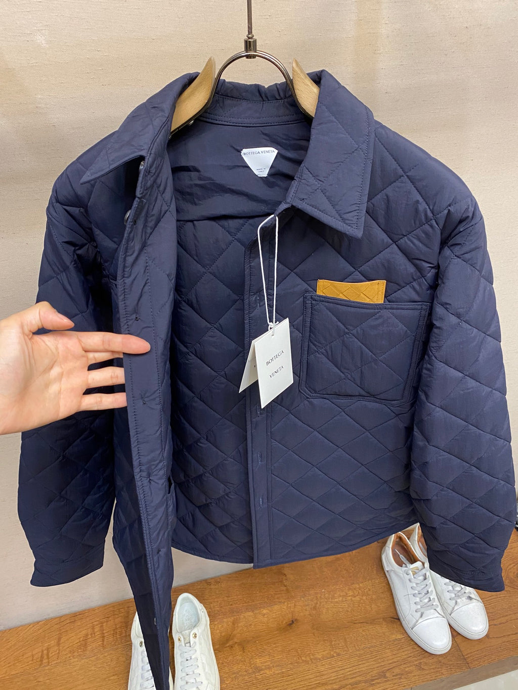 Navy quilted jacket with stand collar and mustard pocket detail
