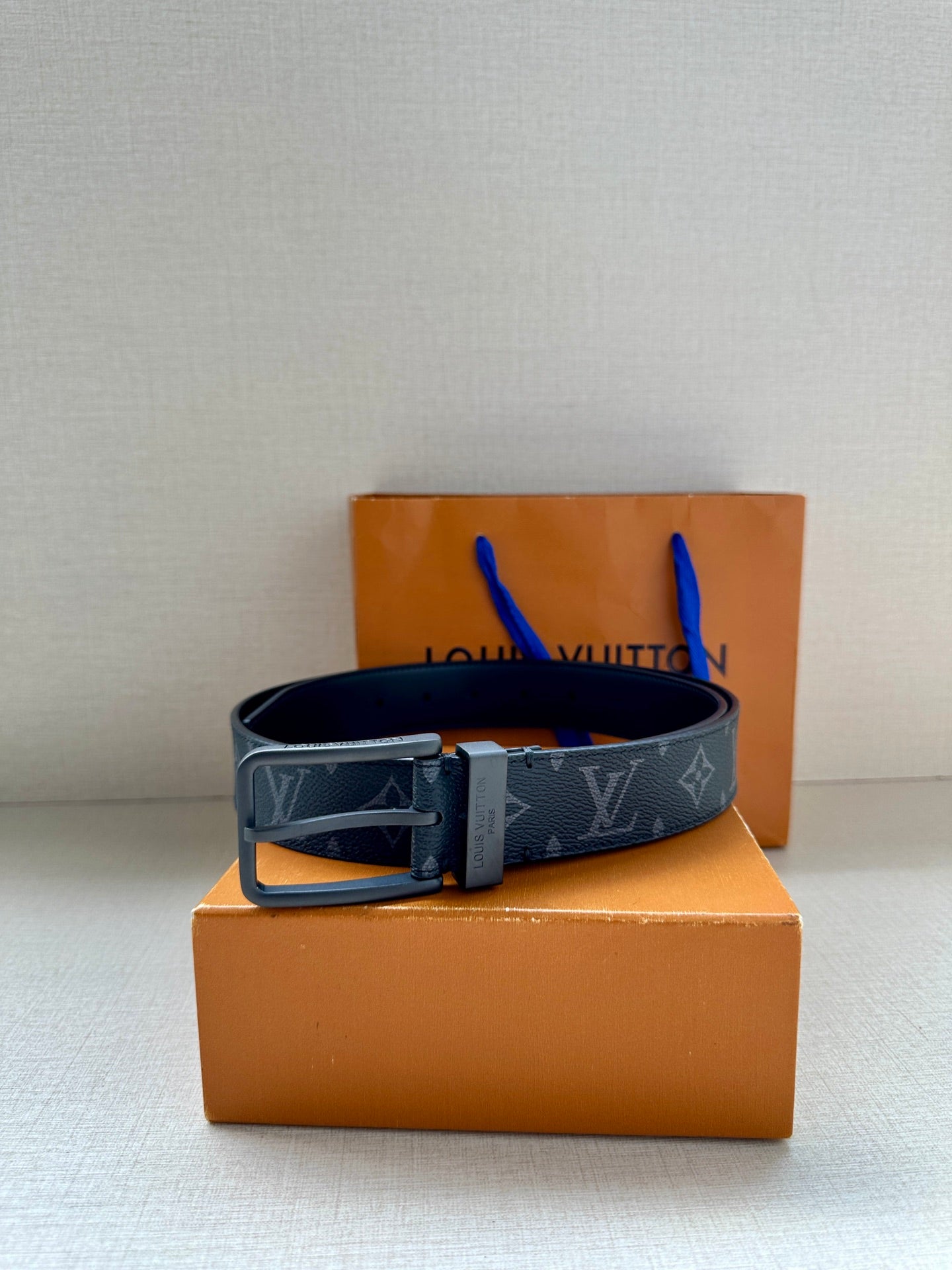 Louis Vuitton monogram belt with dark blue patterned strap and metal buckle