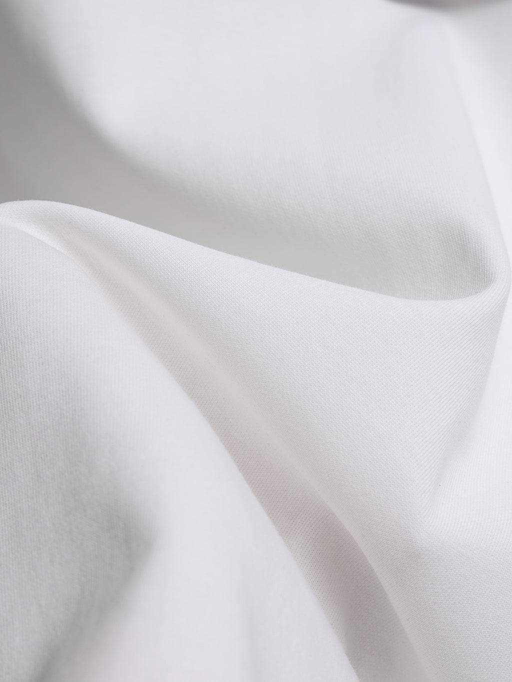 White T-shirt fabric close-up with soft knit texture