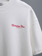 White T-shirt with red Christian Dior Couture logo print at center chest