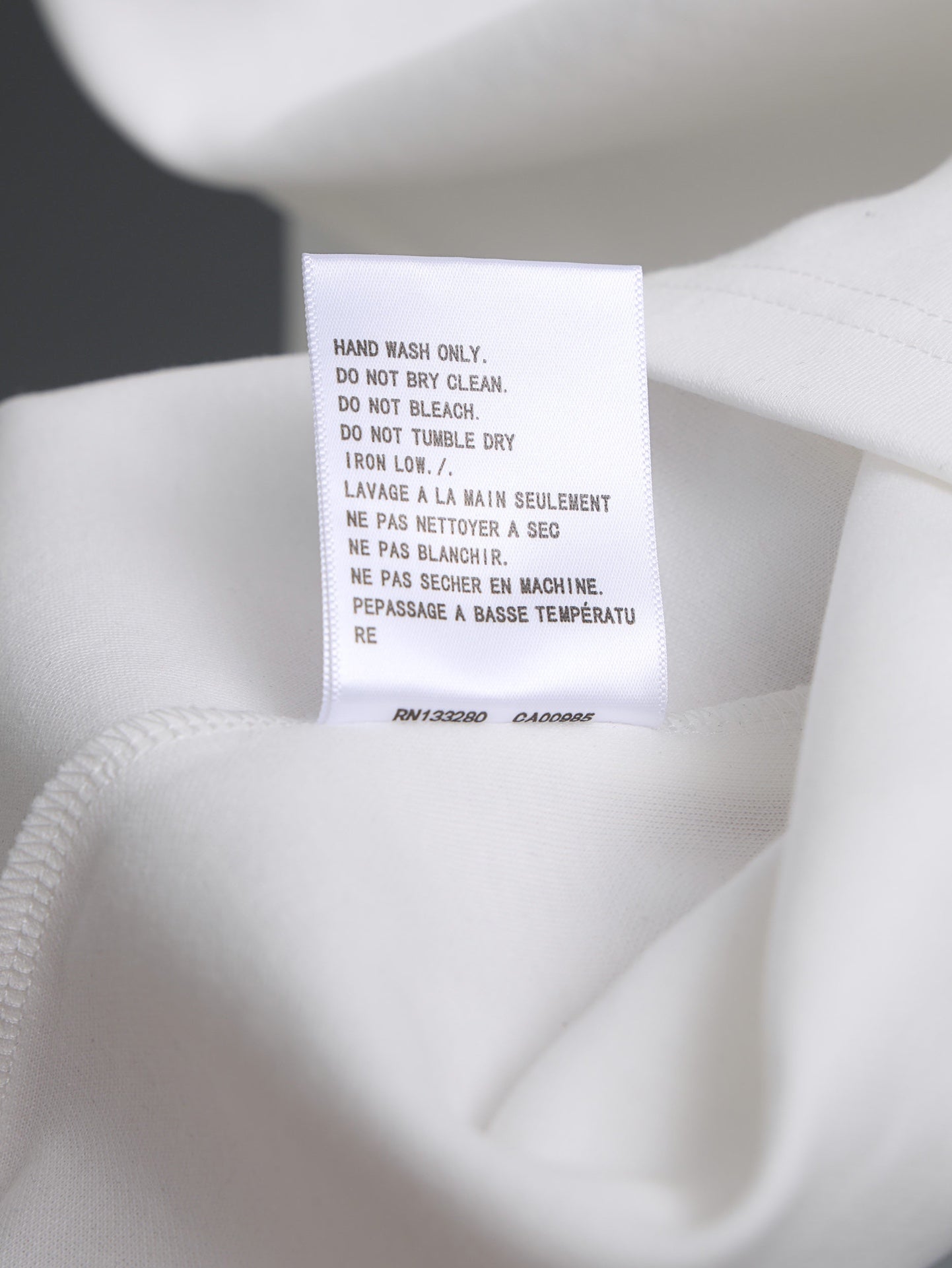 White garment care label tag at neckline