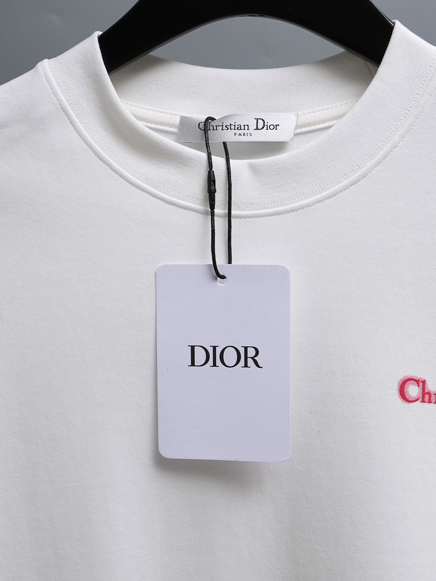 White crewneck T-shirt with collar label and hanging price tag
