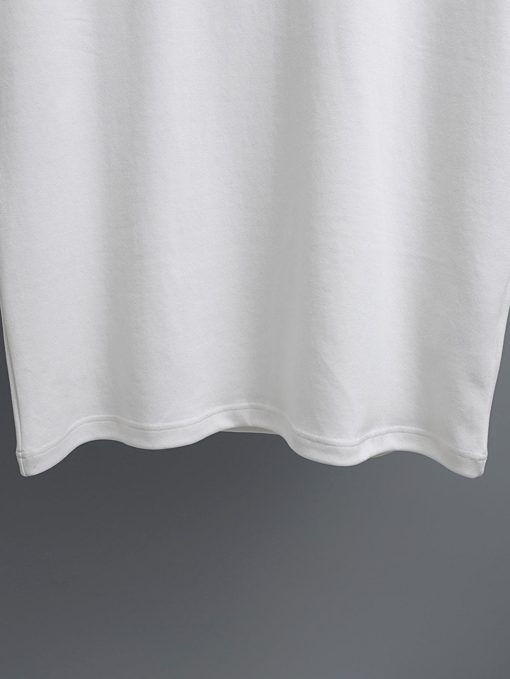 White T-shirt hem with clean stitched bottom edge