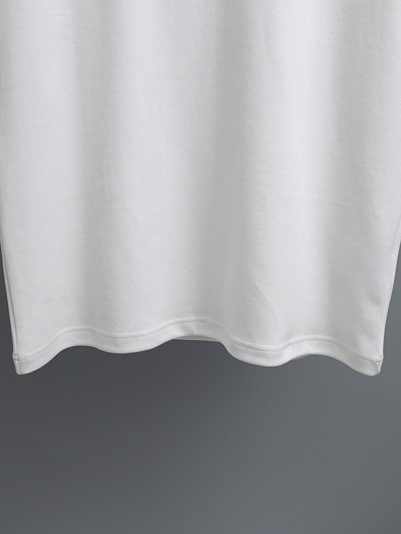 White T-shirt hem with clean stitched bottom edge