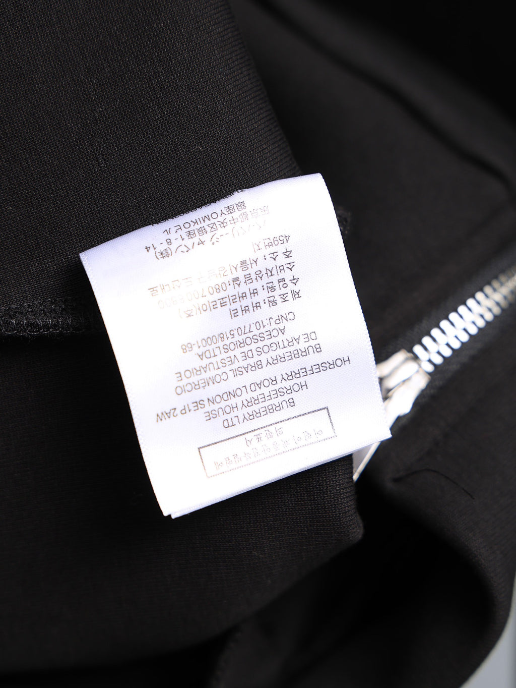 Black long-sleeve top sleeve cuff with size label, brushed fabric
