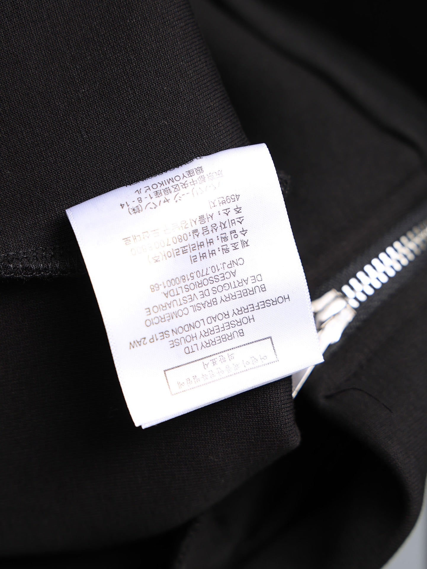 Black long-sleeve top sleeve cuff with size label, brushed fabric