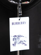 Black zip-up hoodie with hanging Burberry logo tag and silver zipper pull