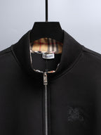 Black zip-up hoodie with plaid-lined neck and silver front zipper