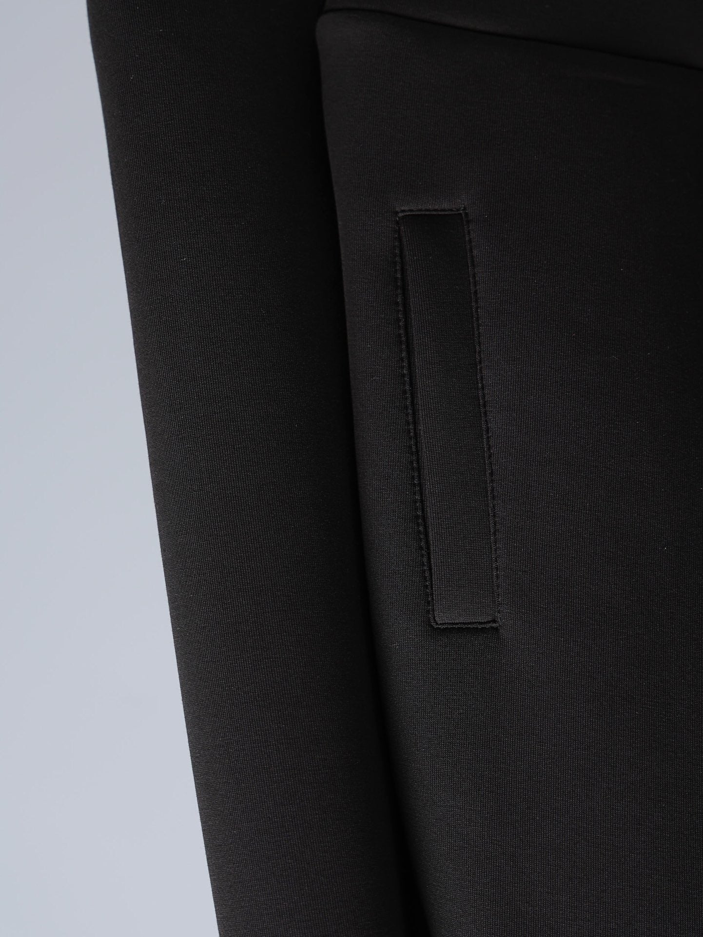 Black jacket with rectangular patch pocket and stitched trim