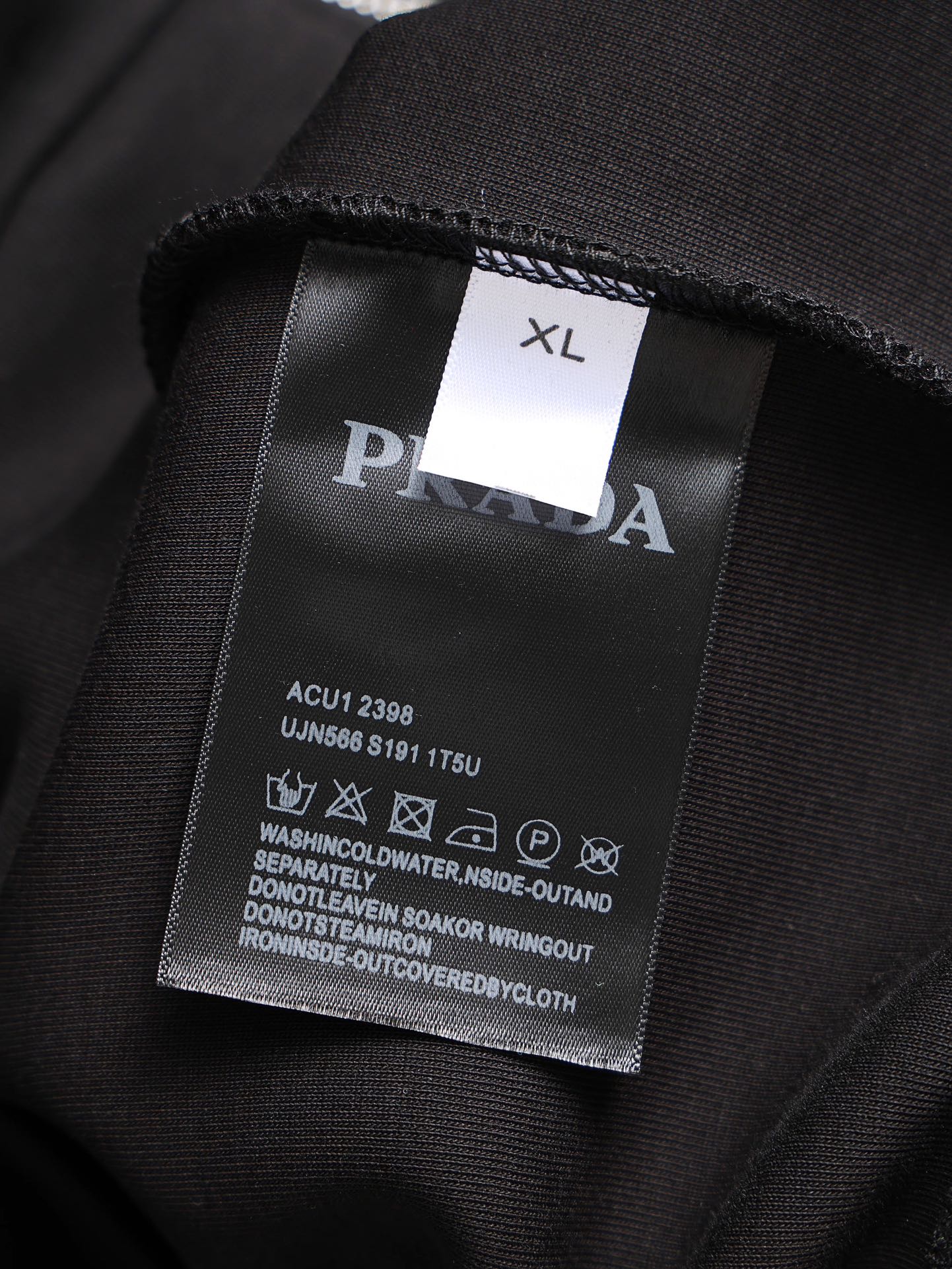 Black jacket interior size XL tag with PRADA branding
