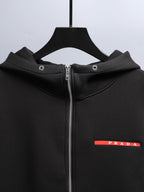 Black zip-up hooded jacket with metal zipper and Prada logo label