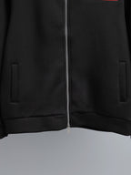 Black zip-up jacket with central zipper and side welt pockets