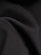 Black jacket fabric close-up with fine grain texture