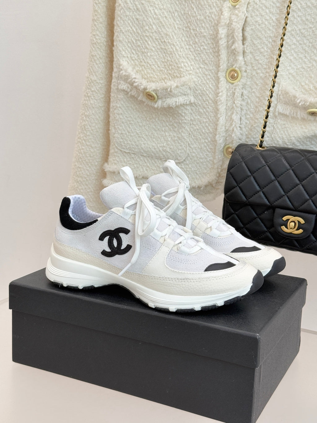Chanel white and black sneakers with lace-up front and logo detail on side