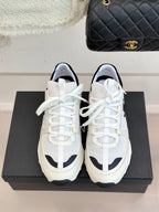 Chanel white lace-up sneakers with black-trim details and cushioned tongue
