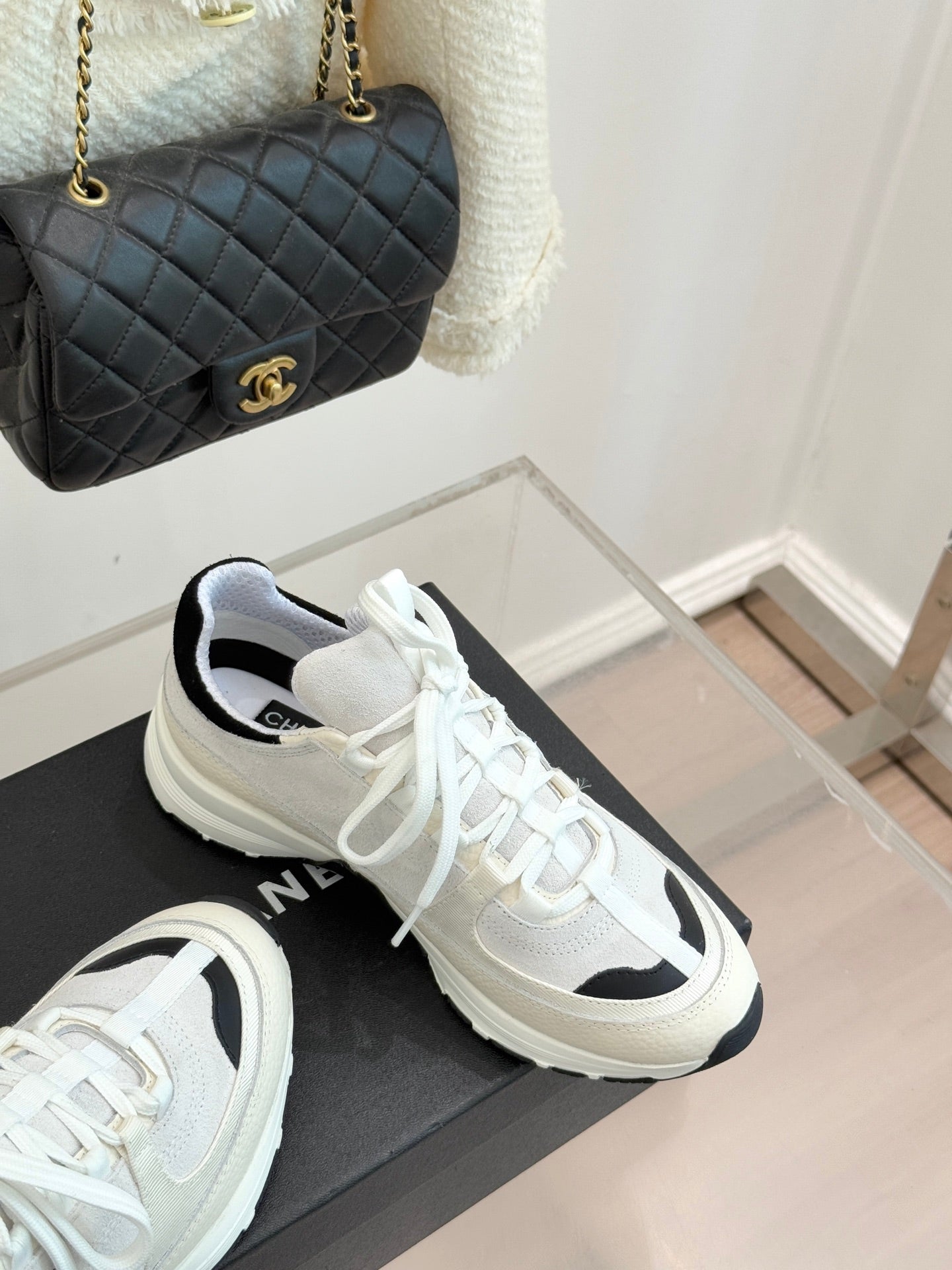 Chanel white sneakers with black side inserts and white laces on black box